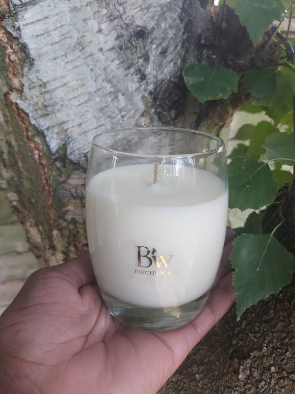 Birchwick candle in a curved glass jar.